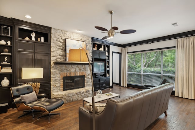 living room featuring dark wood-style floors, ceiling fan, a fireplace, and visible vents