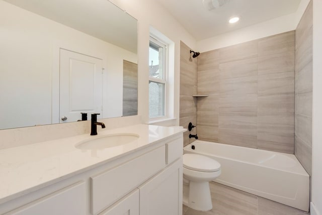 bathroom featuring toilet,  shower combination, and vanity