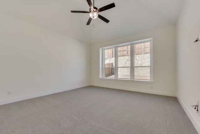 unfurnished room with baseboards, ceiling fan, lofted ceiling, and light colored carpet