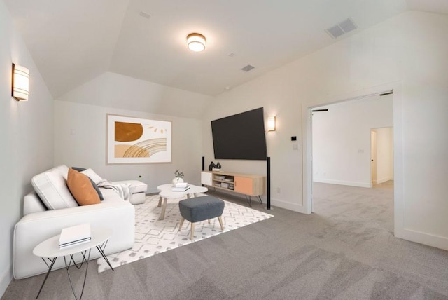 carpeted living area with lofted ceiling, visible vents, and baseboards