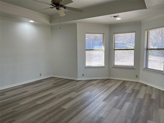 unfurnished room with ornamental molding, wood finished floors, and visible vents