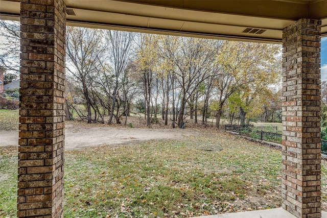 view of yard featuring fence and visible vents