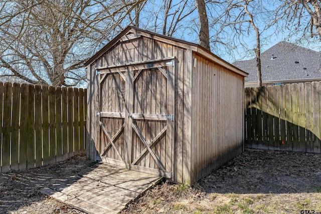 view of shed with a fenced backyard