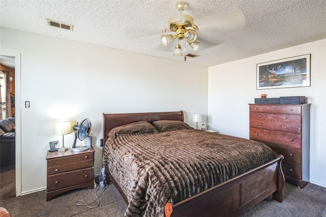 bedroom with baseboards, carpet flooring, visible vents, and a textured ceiling