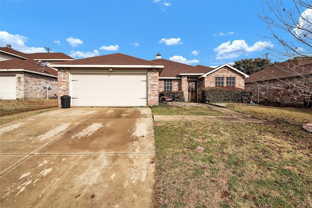 ranch-style home featuring driveway, a chimney, an attached garage, a front lawn, and brick siding