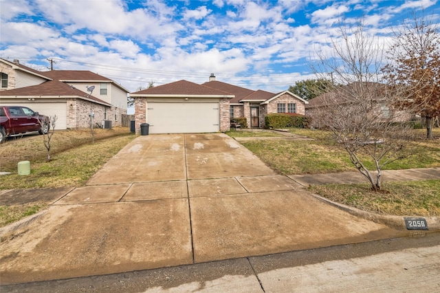 view of front of property featuring driveway, an attached garage, and brick siding