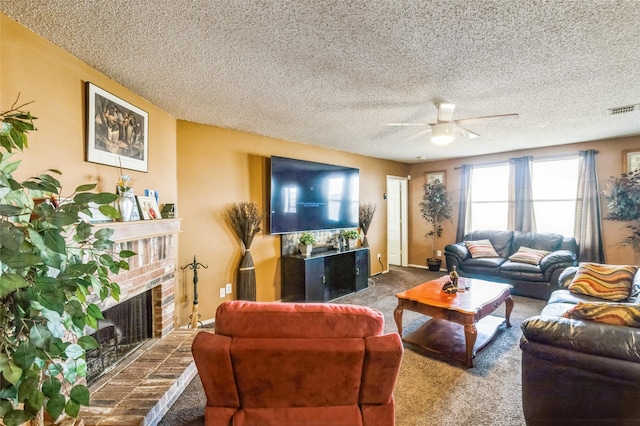 living room with carpet, visible vents, a brick fireplace, ceiling fan, and a textured ceiling