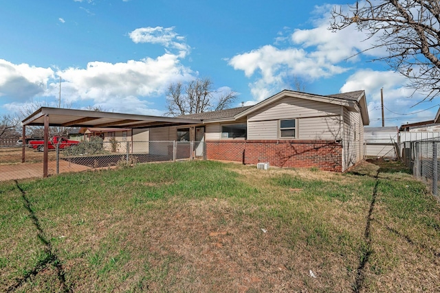 view of front of house with brick siding, a front lawn, and fence