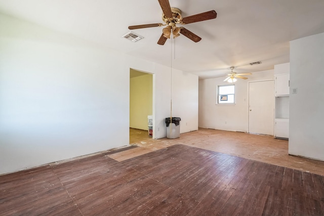 unfurnished living room with a ceiling fan, visible vents, and wood finished floors