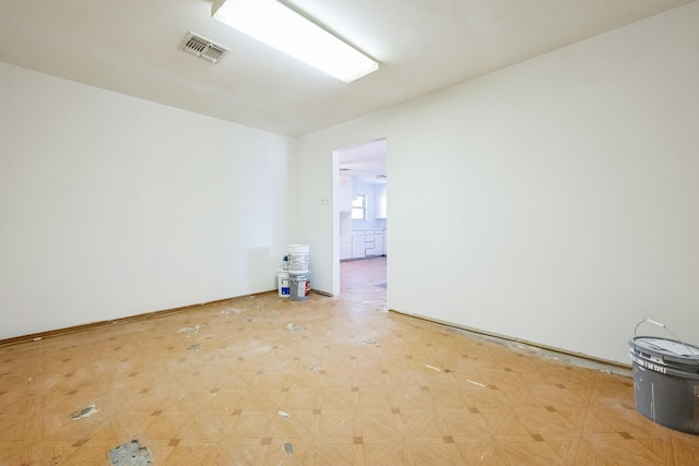 unfurnished room with visible vents and light floors