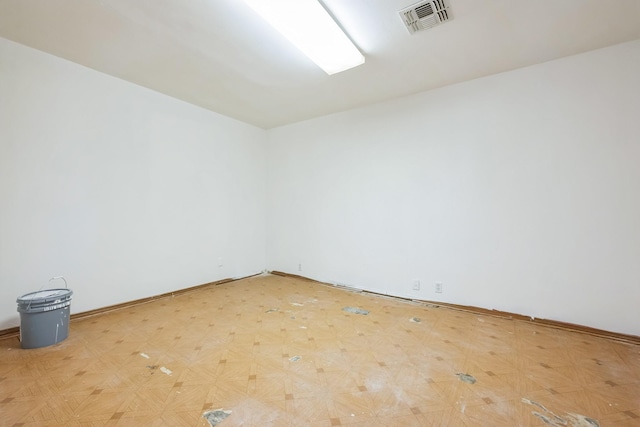 unfurnished room featuring light floors and visible vents