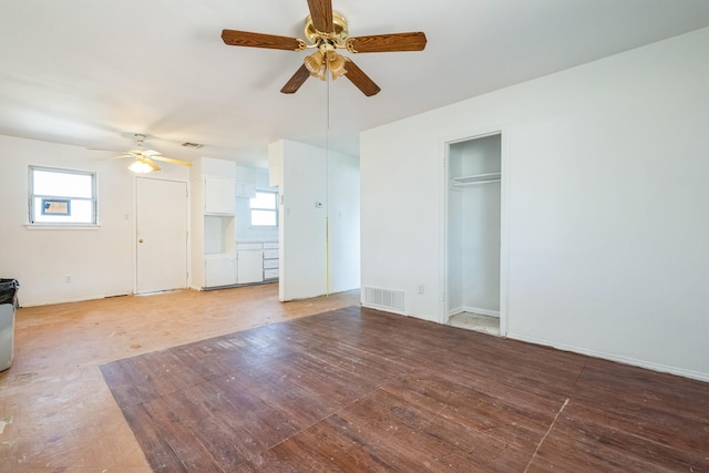 unfurnished living room featuring light wood-type flooring, visible vents, and plenty of natural light