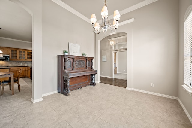 dining area with an inviting chandelier, arched walkways, and ornamental molding