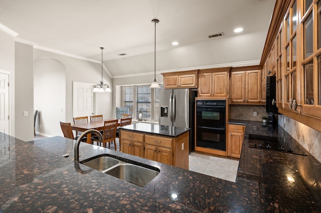 kitchen featuring a sink, visible vents, black appliances, tasteful backsplash, and crown molding