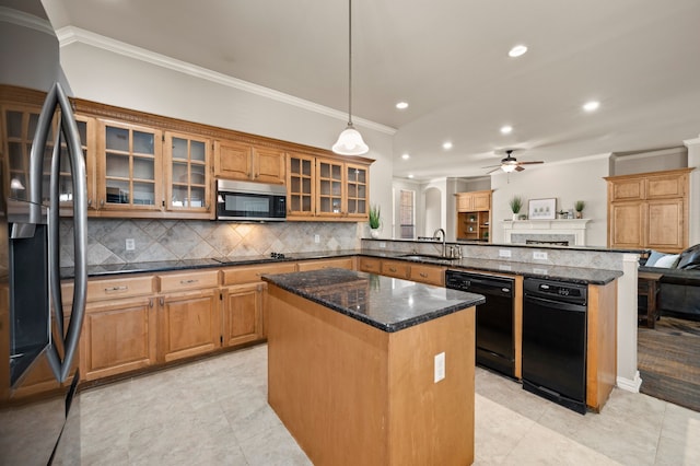 kitchen featuring ornamental molding, a sink, a kitchen island, a peninsula, and black appliances