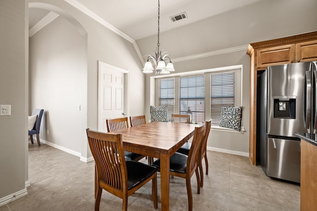 dining area featuring visible vents, arched walkways, ornamental molding, vaulted ceiling, and a chandelier