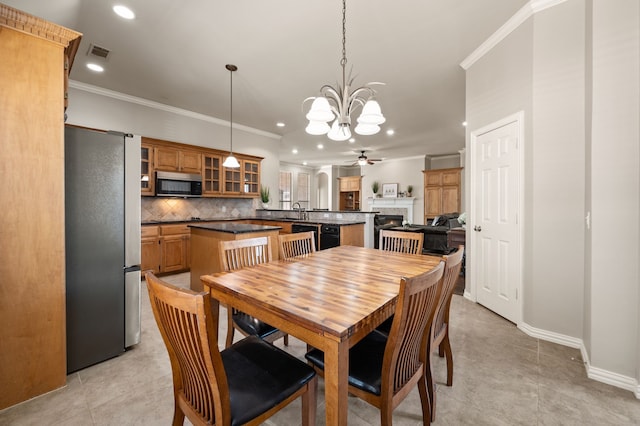 dining area with visible vents, a fireplace, and ornamental molding