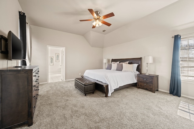 bedroom with visible vents, baseboards, a ceiling fan, light colored carpet, and ensuite bath