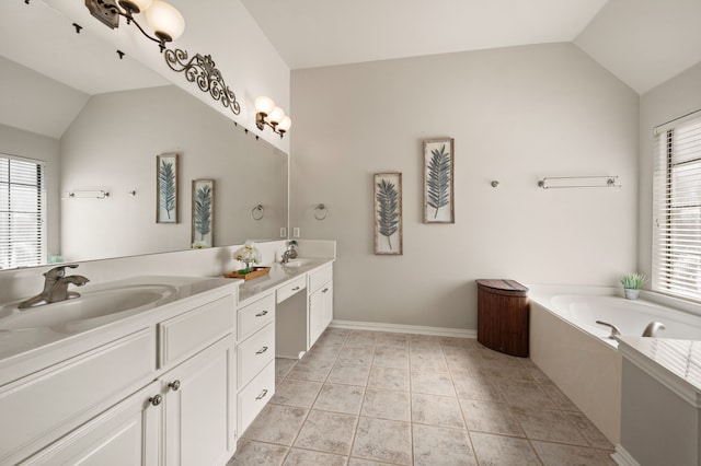 bathroom with vaulted ceiling, a sink, and tile patterned floors