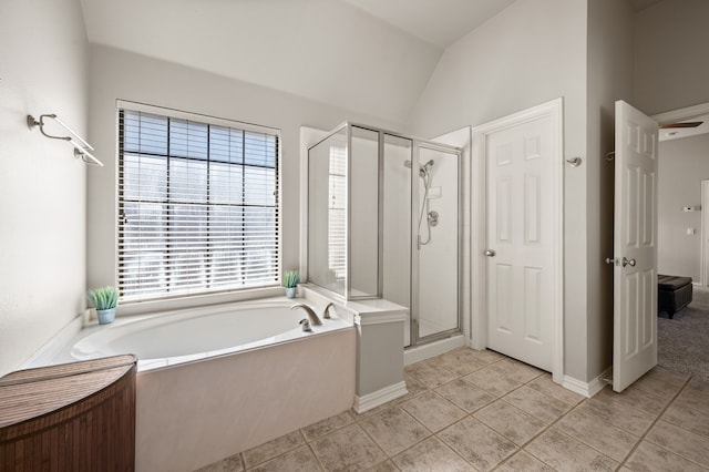 full bathroom featuring a stall shower, a garden tub, lofted ceiling, and tile patterned floors