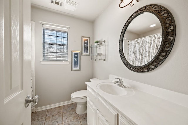 bathroom with visible vents, toilet, vanity, baseboards, and tile patterned floors