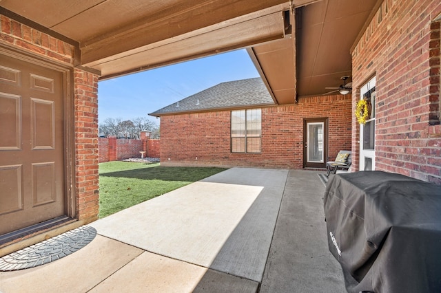 view of patio / terrace with a grill, fence, and ceiling fan