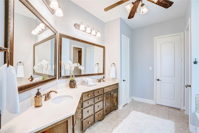 bathroom with double vanity, a sink, baseboards, and tile patterned floors