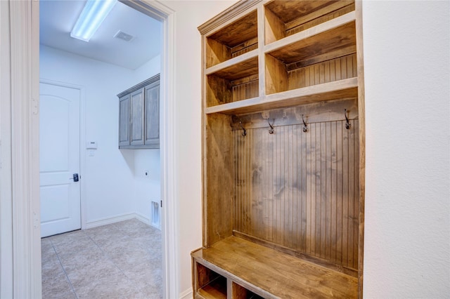 mudroom with light tile patterned floors, visible vents, and baseboards