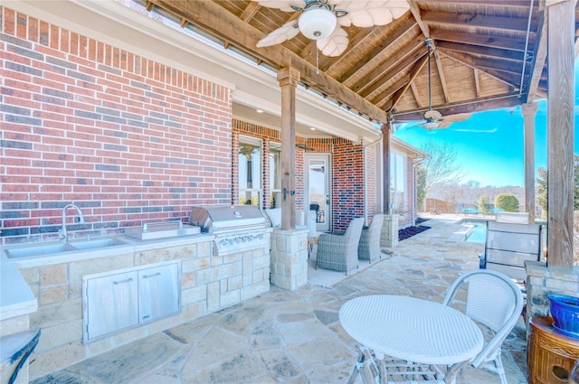 view of patio with a grill, ceiling fan, a sink, and area for grilling