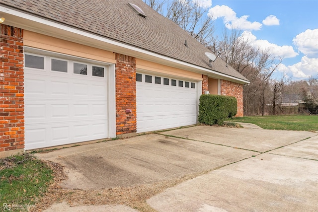 view of side of home featuring concrete driveway, brick siding, and roof with shingles