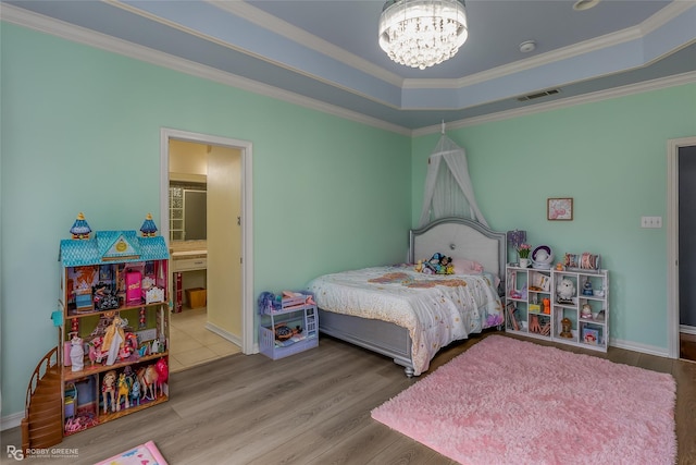 612 Kari Crk, Bossier City, LA 71111 - bedroom with crown molding, wood finished floors, an inviting chandelier, a tray ceiling, and visible vents