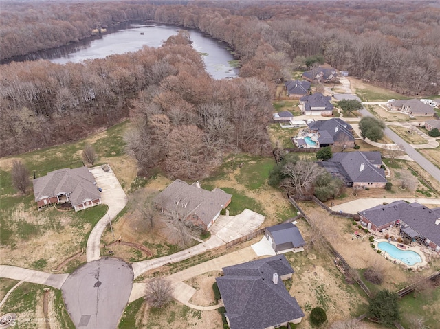 birds eye view of property with a water view and a forest view