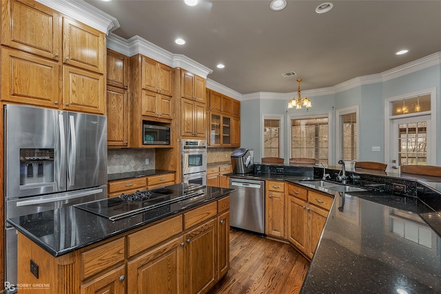 612 Kari Crk, Bossier City, LA 71111 - kitchen with stainless steel appliances, a sink, dark wood finished floors, backsplash, and a chandelier