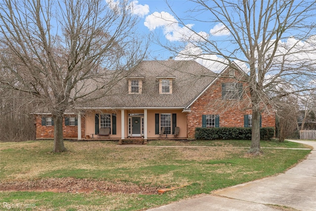 612 Kari Crk, Bossier City, LA 71111 - view of front of home with a porch, a front yard, stucco siding, brick siding, and roof with shingles