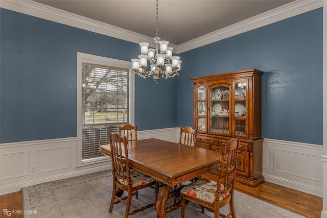 612 Kari Crk, Bossier City, LA 71111 - dining space featuring crown molding, wood finished floors, a wainscoted wall, and an inviting chandelier