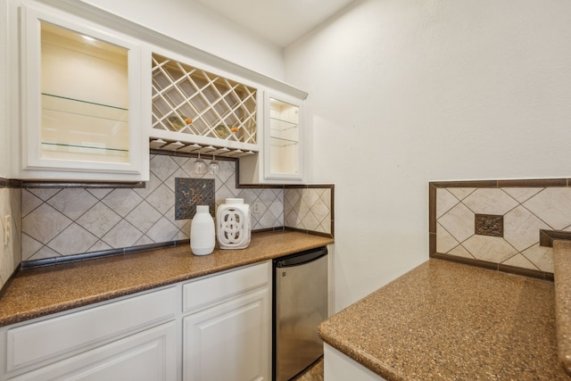 bar with a dry bar, fridge, and backsplash