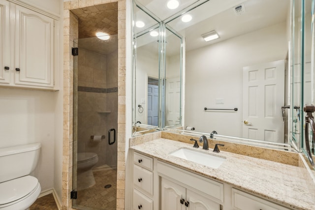 full bath featuring toilet, a shower stall, visible vents, and vanity