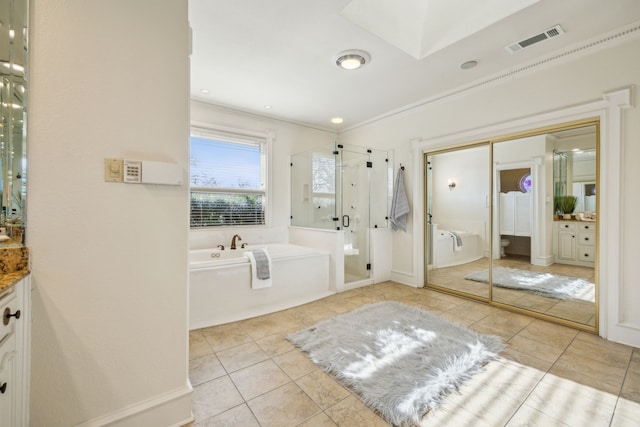 full bathroom with visible vents, vanity, a shower stall, tile patterned flooring, and a bath