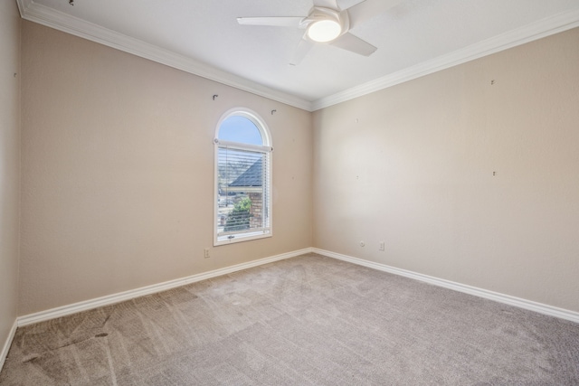 empty room with baseboards, ceiling fan, ornamental molding, and carpet flooring