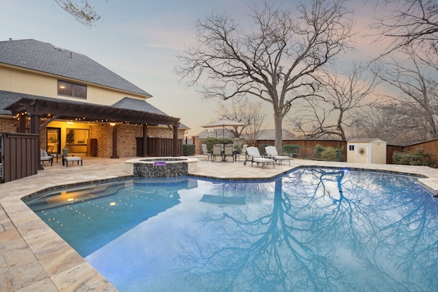 view of pool featuring a storage shed, a patio area, a fenced backyard, and an outbuilding