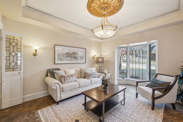 living room with a raised ceiling and baseboards