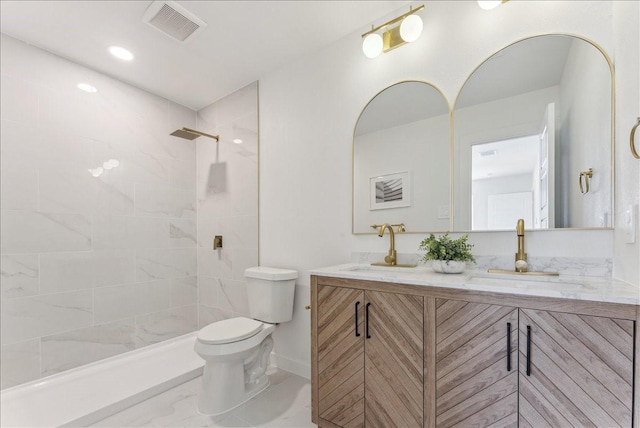 full bathroom featuring visible vents, a sink, toilet, and double vanity