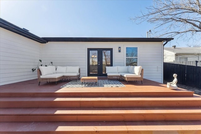 wooden terrace featuring fence, an outdoor hangout area, and french doors