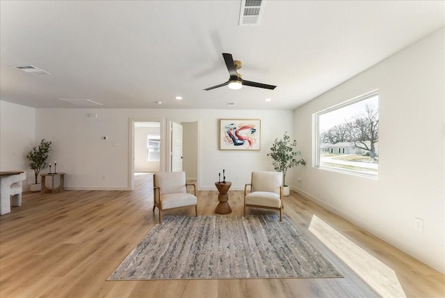 living area featuring a ceiling fan, recessed lighting, visible vents, and light wood-style floors