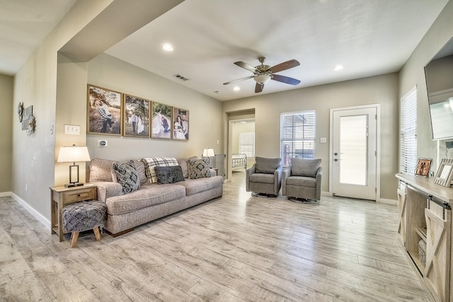 living area with recessed lighting, visible vents, ceiling fan, light wood-type flooring, and baseboards