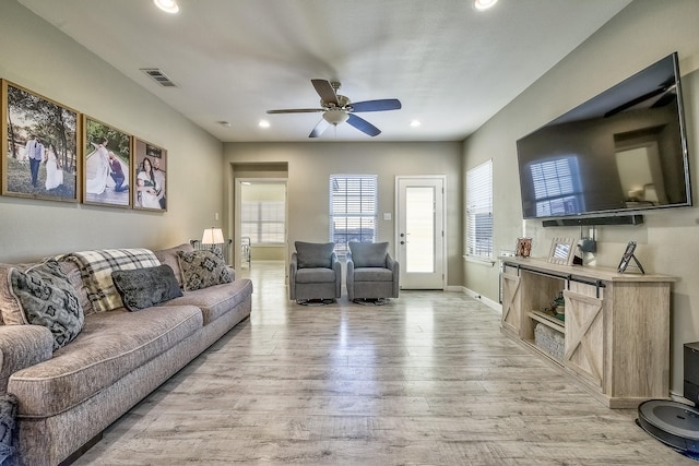 living room featuring ceiling fan, light wood-style flooring, recessed lighting, visible vents, and baseboards