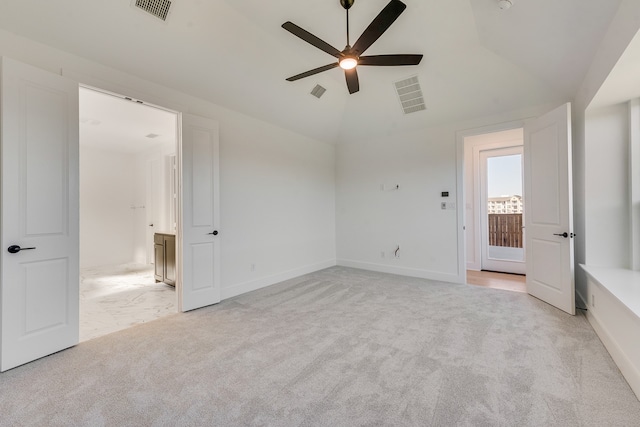 unfurnished bedroom with lofted ceiling, visible vents, and light colored carpet