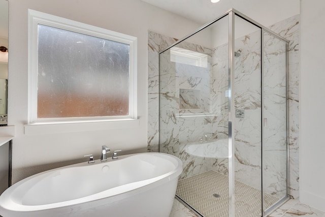 bathroom with a healthy amount of sunlight, marble finish floor, a marble finish shower, and a soaking tub