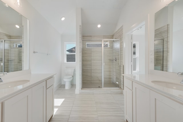 bathroom featuring a stall shower, two vanities, and a sink