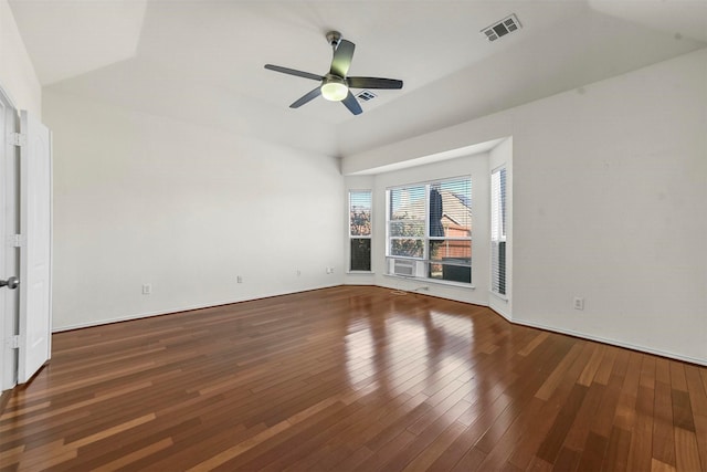 empty room with wood-type flooring, visible vents, and ceiling fan